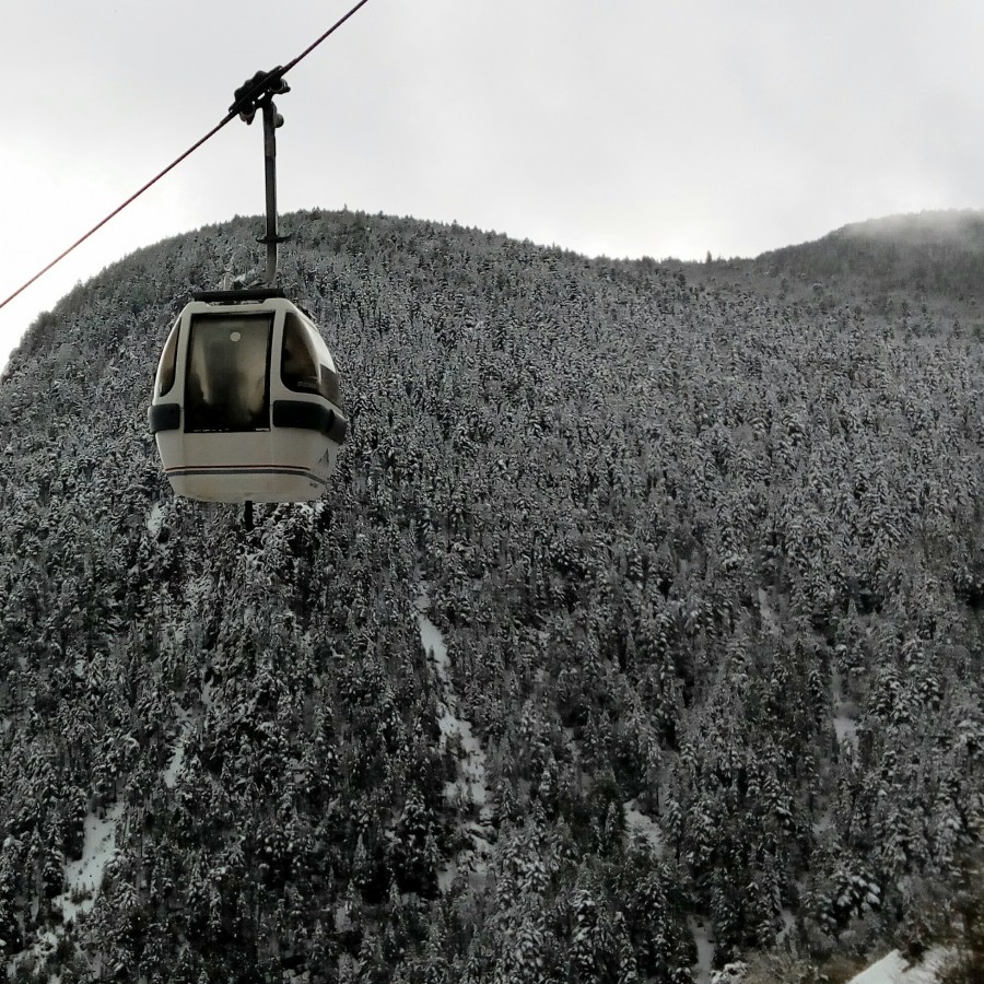 The gondola going up on a white day